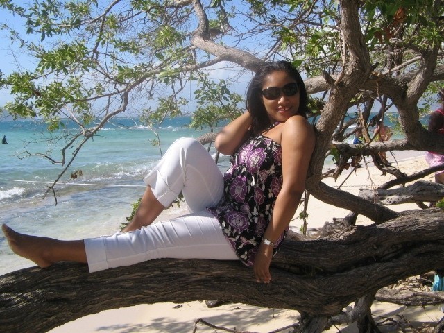 Monique sitting on tree branch at Lime Cay - Kingston - Jamaica