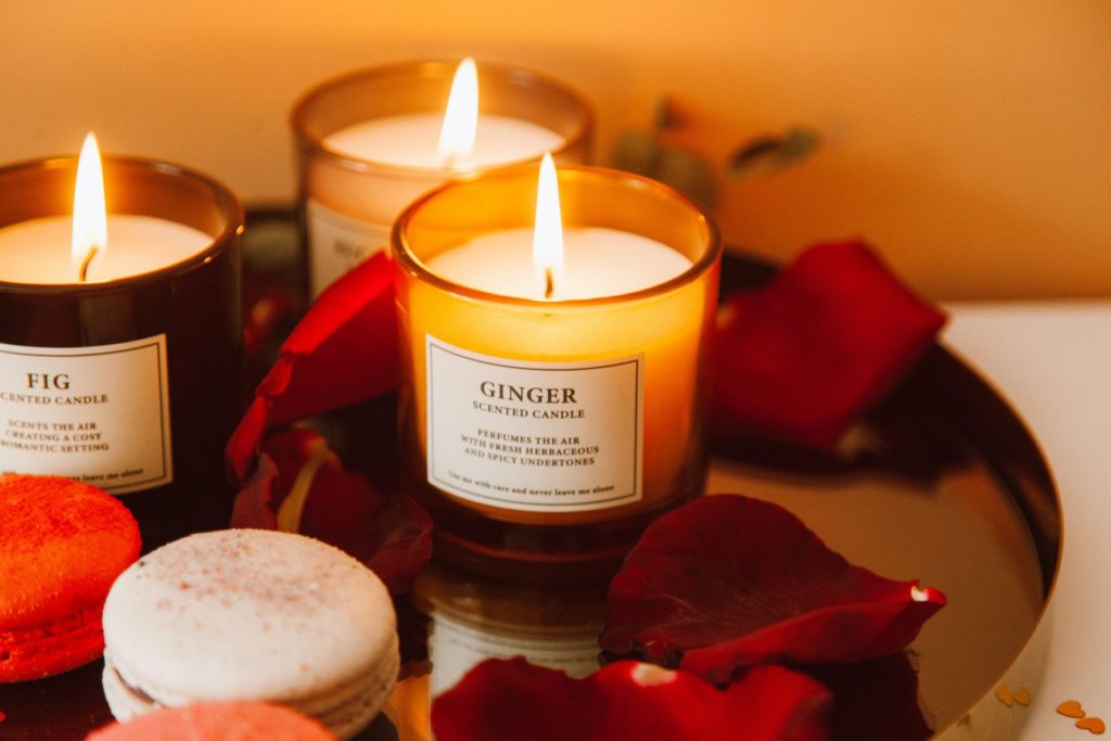 Lit scented ginger candles decorated with rose petals
