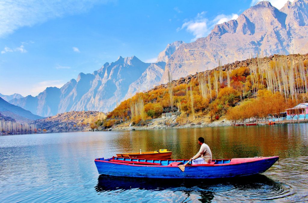 Man rowing blue boat on Kachura Lake, Skardu, Pakistan
