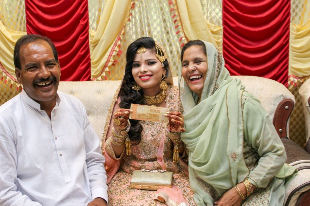 Pakistani Bride holding Pakistani Rupees