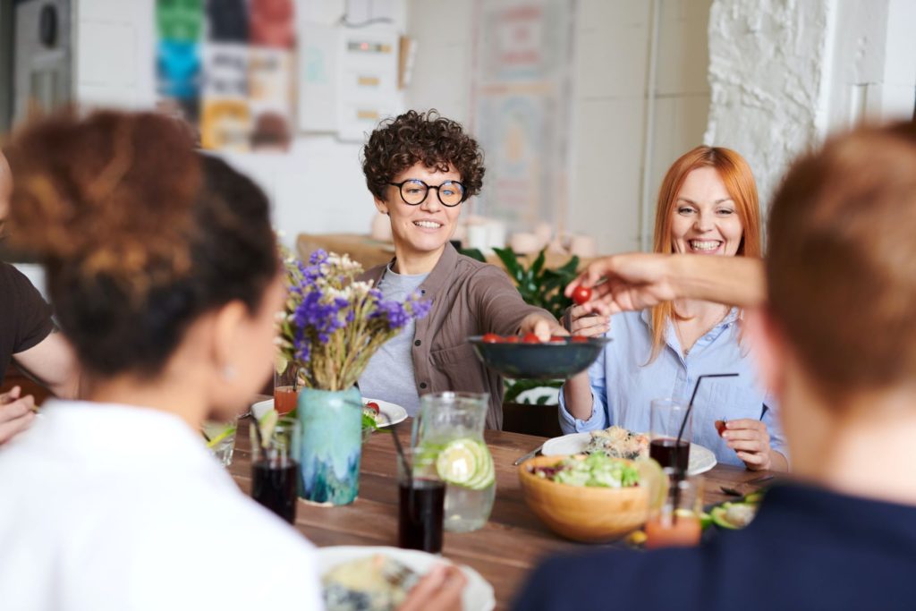 Friends enjoying healthy dinner at table