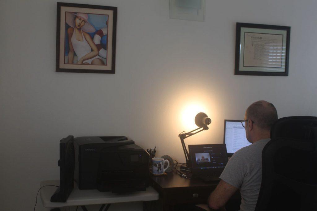 Nick Abbott on Zoom Call in Office with Desk Light