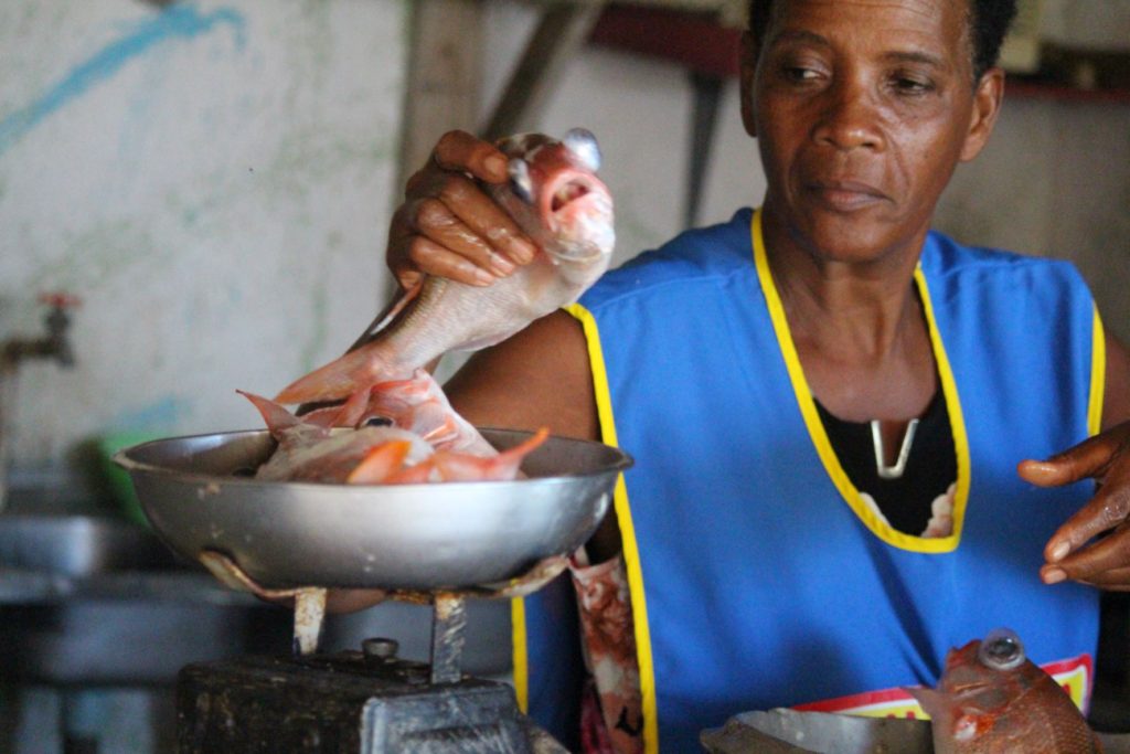 Beulah preparing fish at Fanso’s Water’s Edge Bar & Restaurant, Robin's Bay, St. Mary, Jamaica