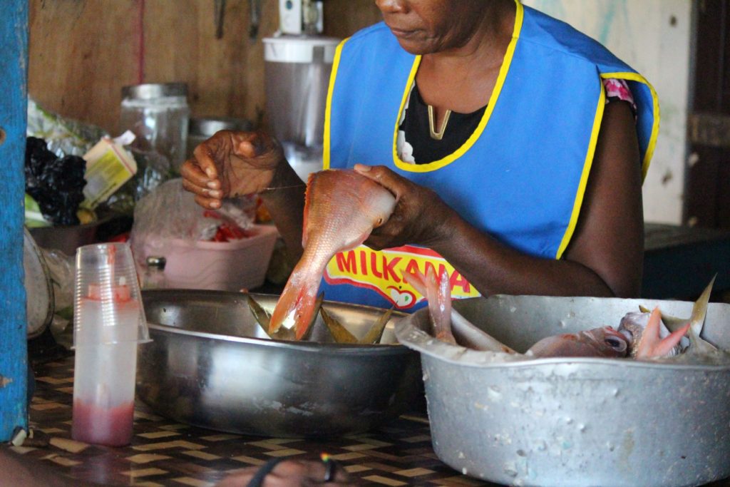 Beulah preparing fish at Fanso’s Water’s Edge Bar & Restaurant, Robin's Bay, St. Mary, Jamaica