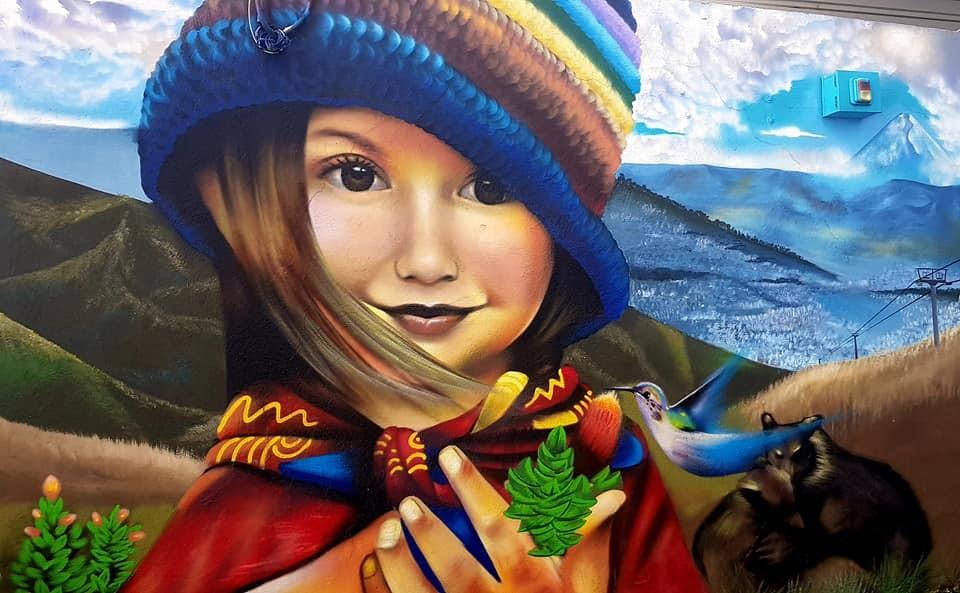 Girl wearing colourful hat in street art, Ecuador