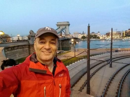 Nick Abbott walking on pedestrian bridge in Budapest