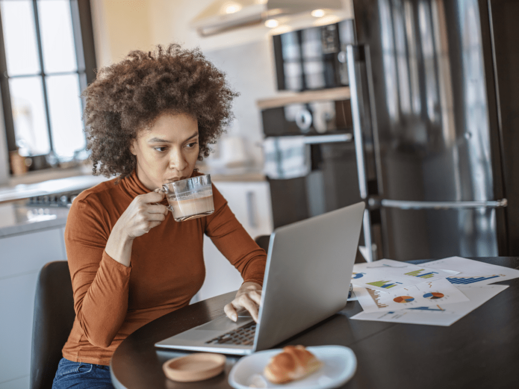 Woman sipping coffee while working from home -Photo from Canva Pro