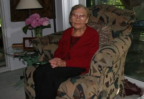 Monique Abbott's Grandmother wearing a red sweater