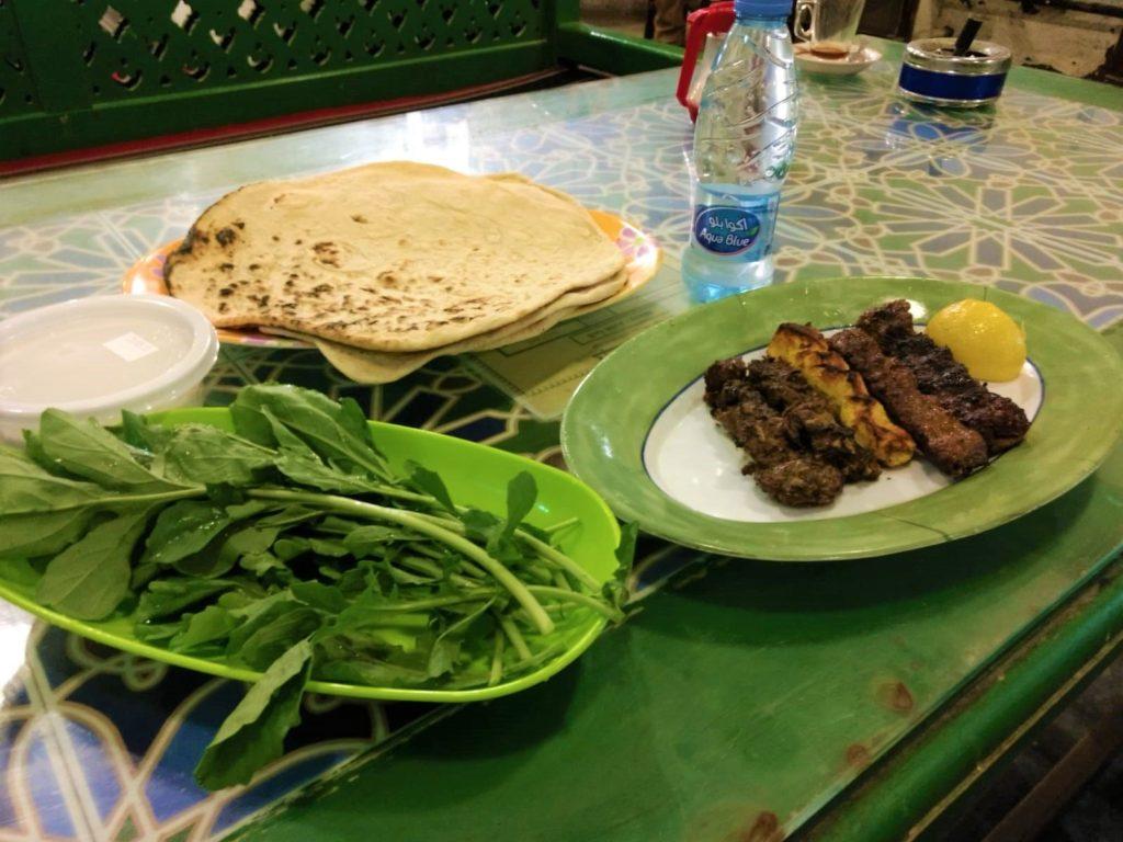 Qatar local dish made from kuboos bread, grilled lamb, arugula and yogurt