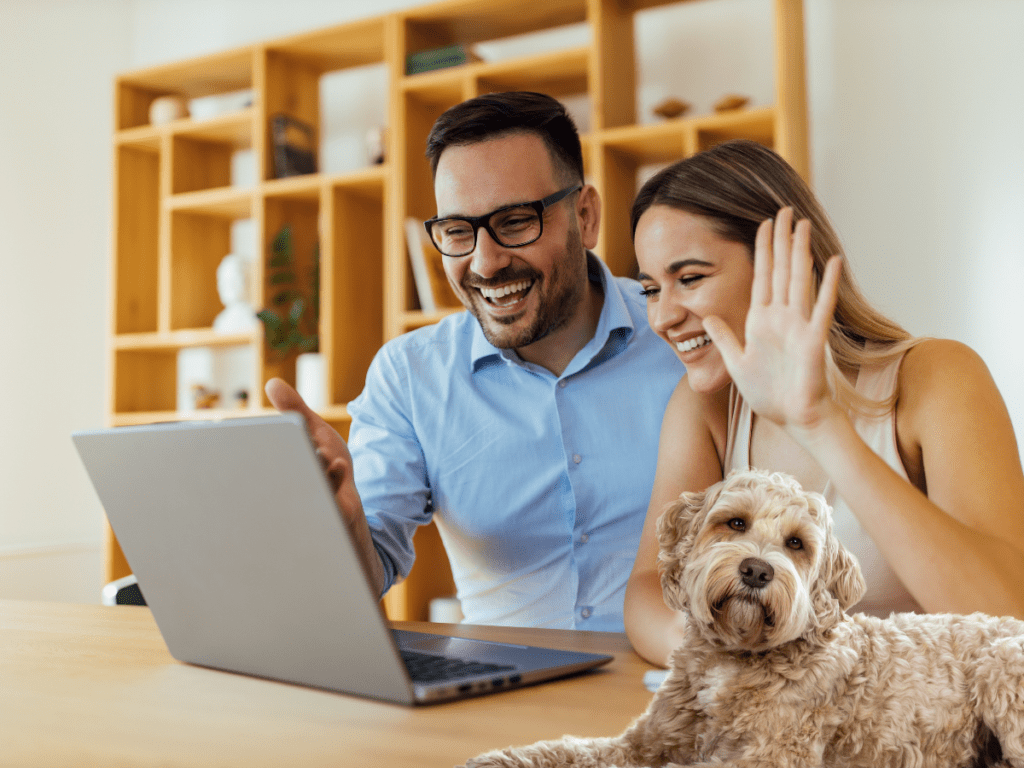 Couple Having Online Chat and dog sitting next to them