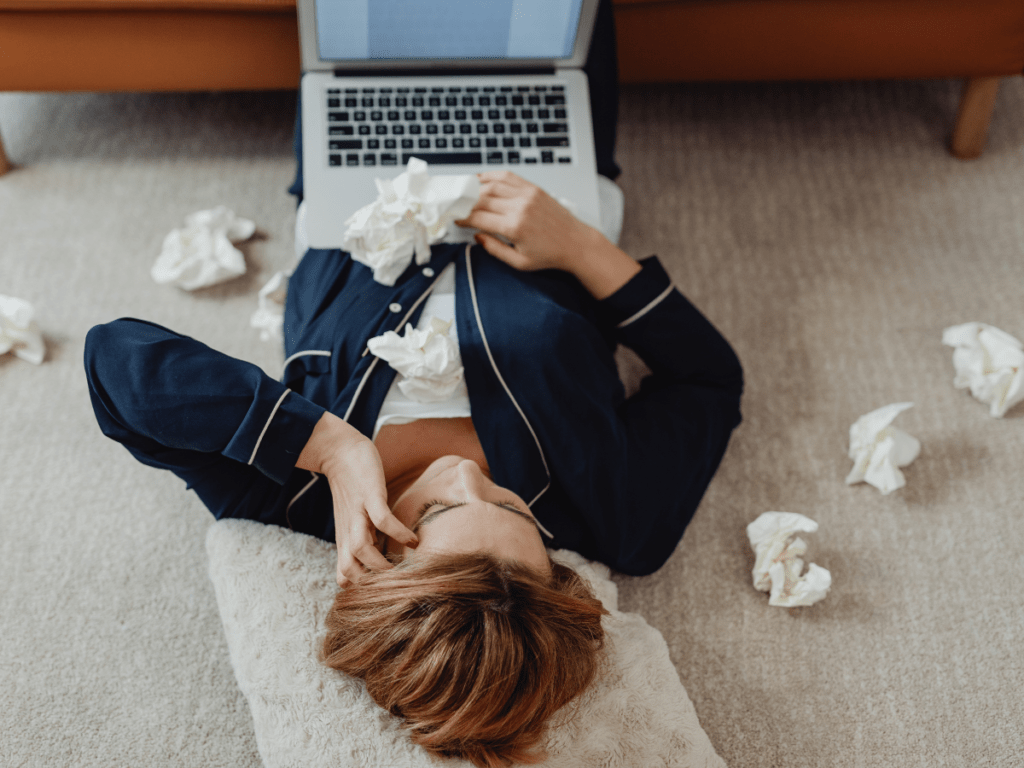 Woman lying on floor with laptop and having a hard time working from home