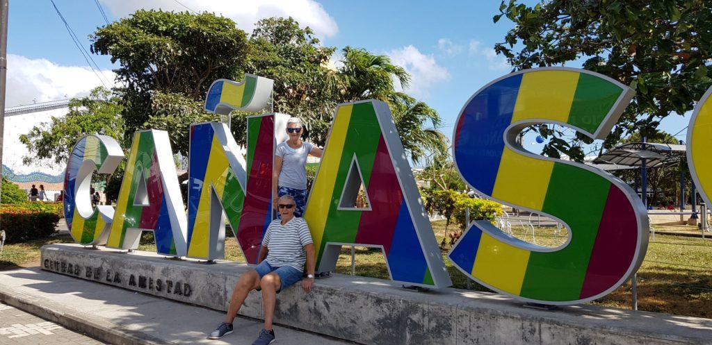 Paul & Jane Abbott standing at the Canas Sign in Costa Rica