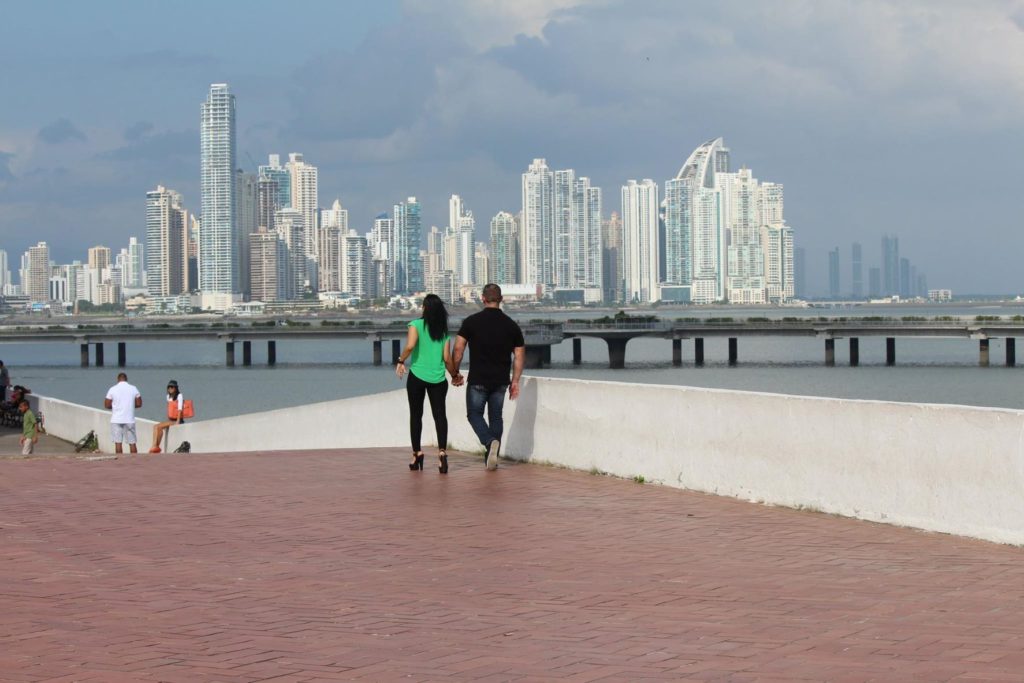 Couple holding hands while walking along Paseo de Las Bovedas, Old Town, Panama