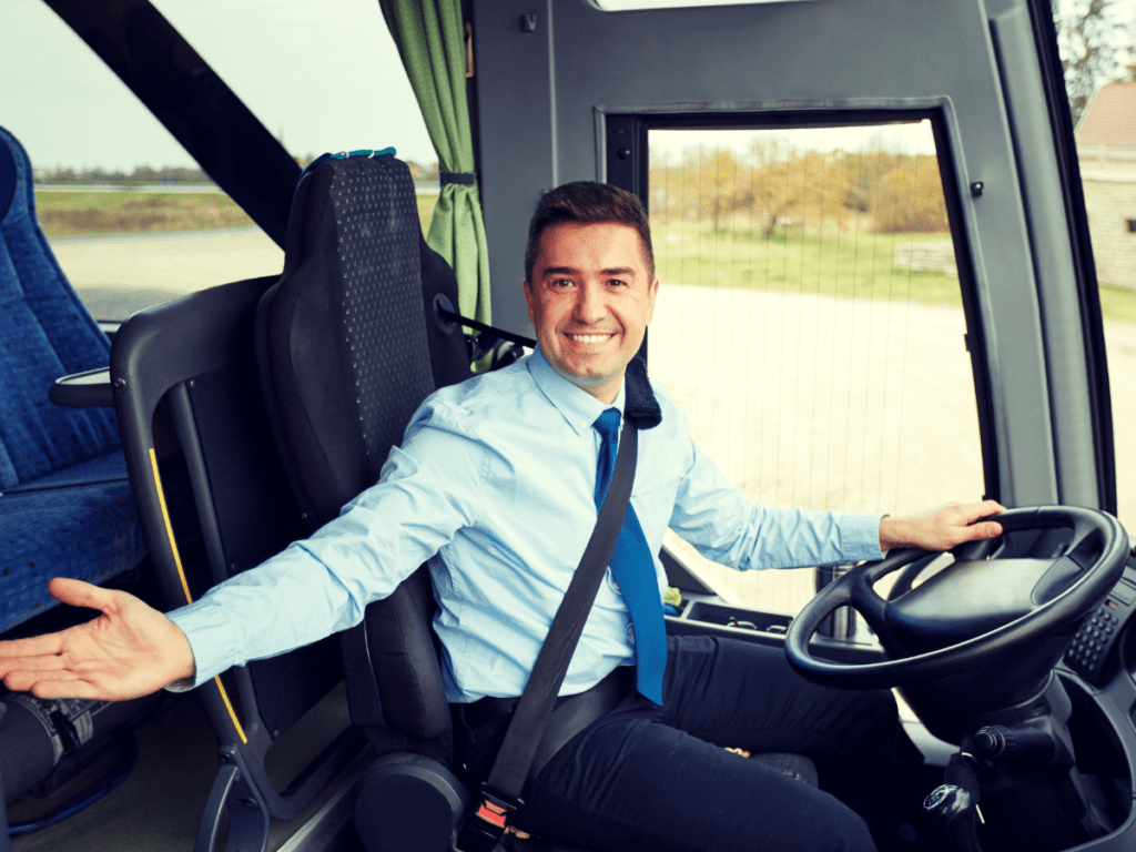 Friendly Bus Driver Seated at Steering Wheel