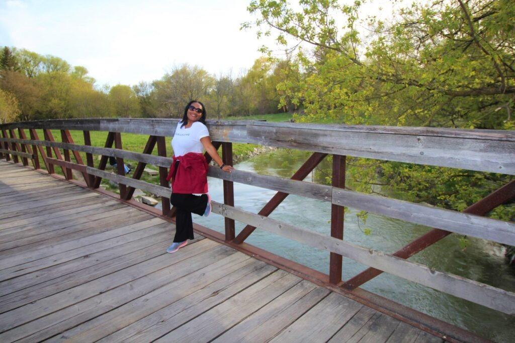 Monique Abbott standing on a bridge over the Humber River, Toronto, Ontario