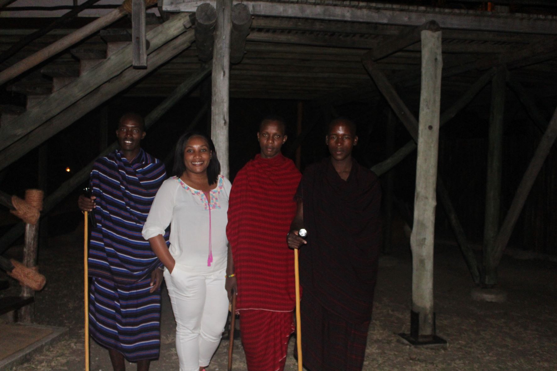 Monique Abbott standing with 3 Maasais at Selous Camp, Tanzania