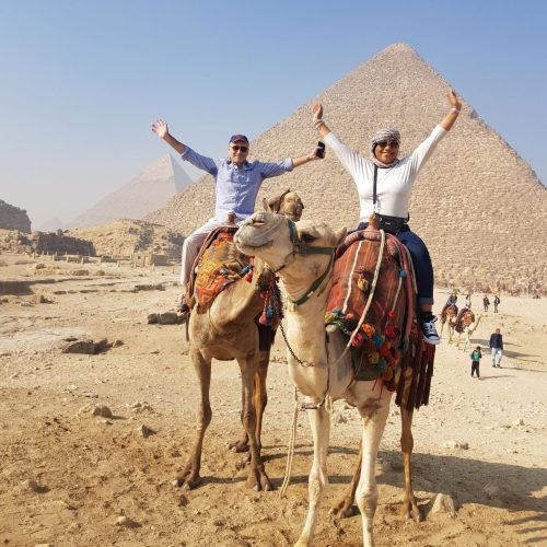 Nick and Monique Abbott riding camels at Pyramids at Giza, Egypt