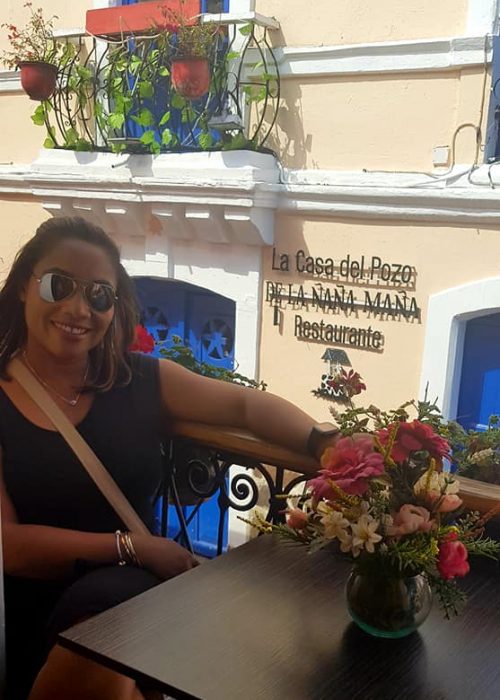 Monique sitting on restaurant balcony located at Calle La Ronda