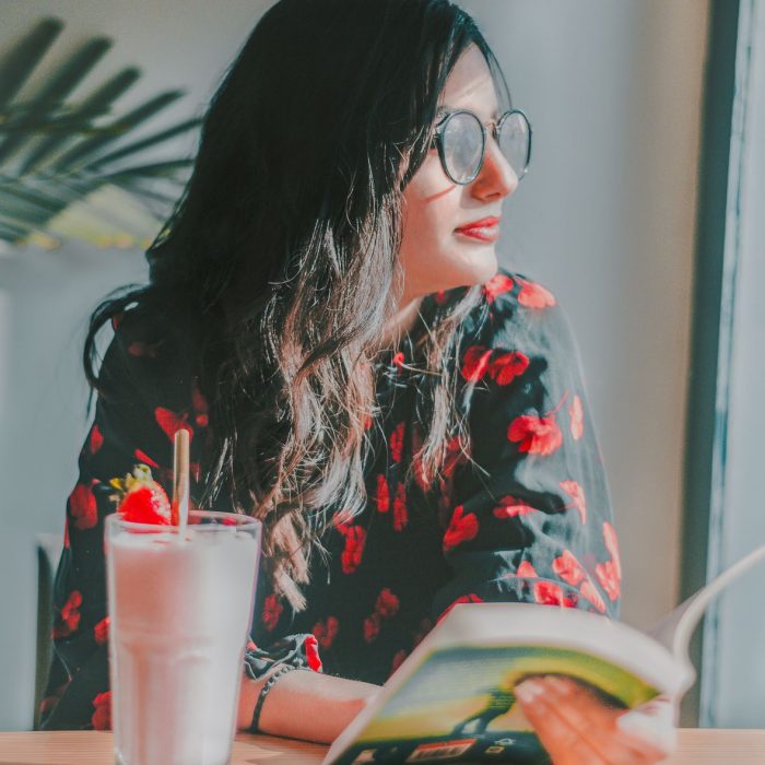 Woman sitting in café reading book